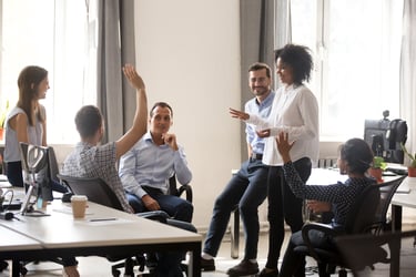 Three men and three women gather in an office for a people ops team meeting to clearly define performance, potential, promotability, and readiness in regards to the talent review process.