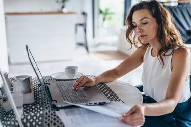 People/HR manager analyzing performance data using laptop