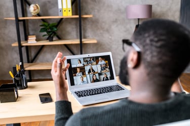 People Ops manager managing a remote team on his laptop from his home office