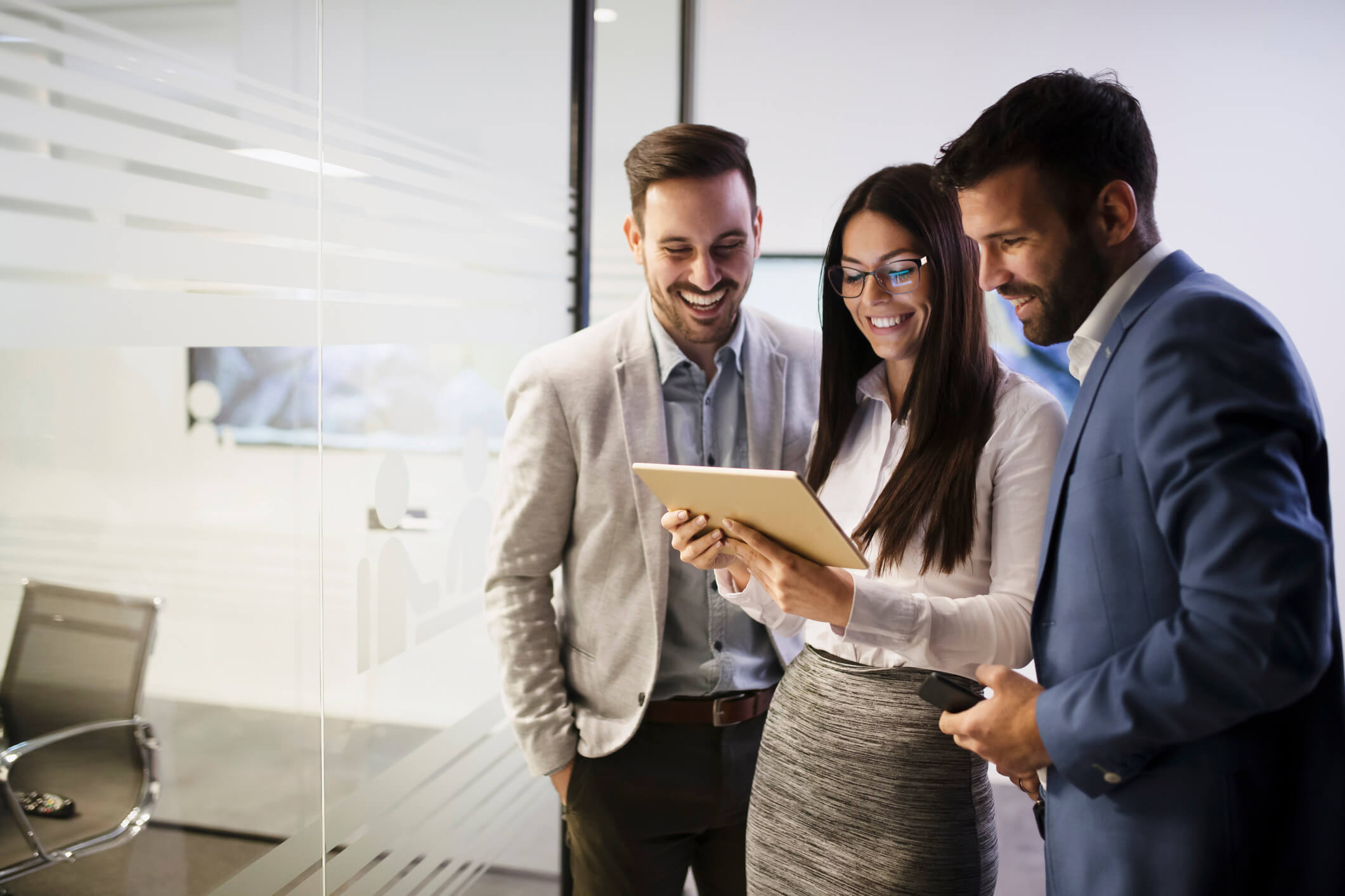 HR team analyzing performance and promotion data using software on tablet to make data-driven decisions about employee promotions